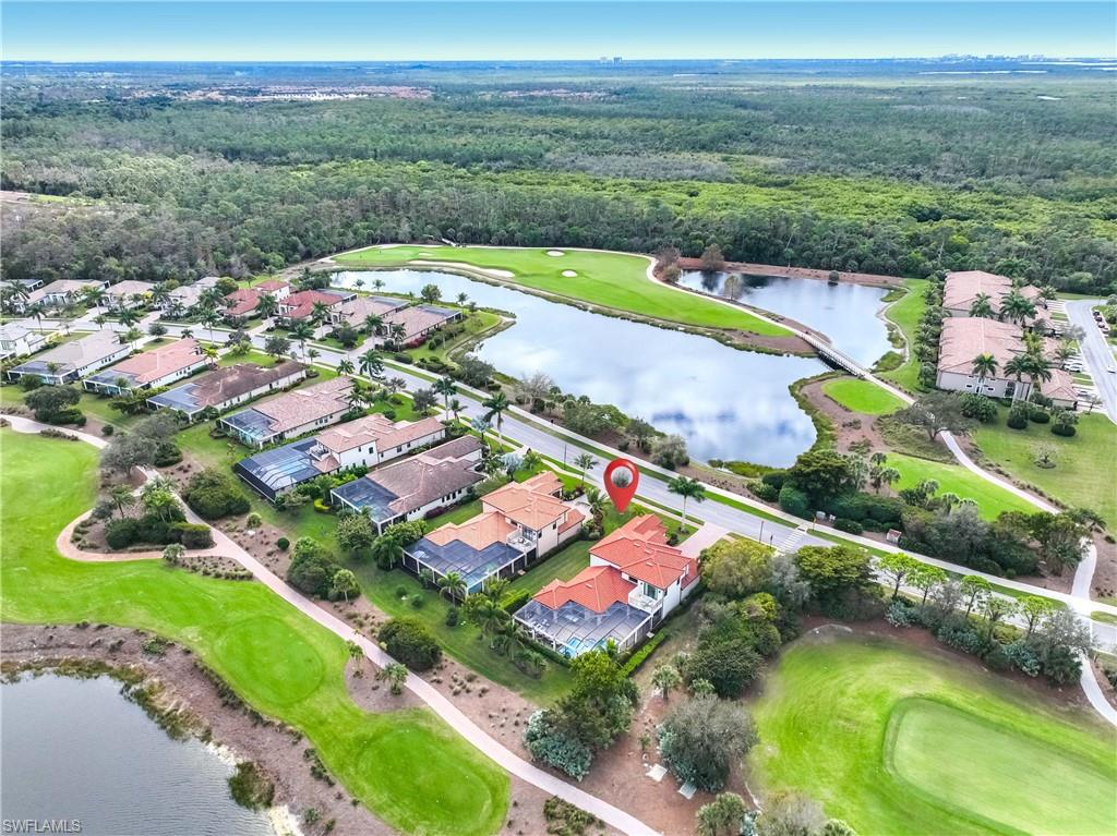 9852 Corso Bello Drive Naples, FL 34113 - Photo 48 of 50 Aerial view of property and surrounding area with a large body of water and nearby suburban area