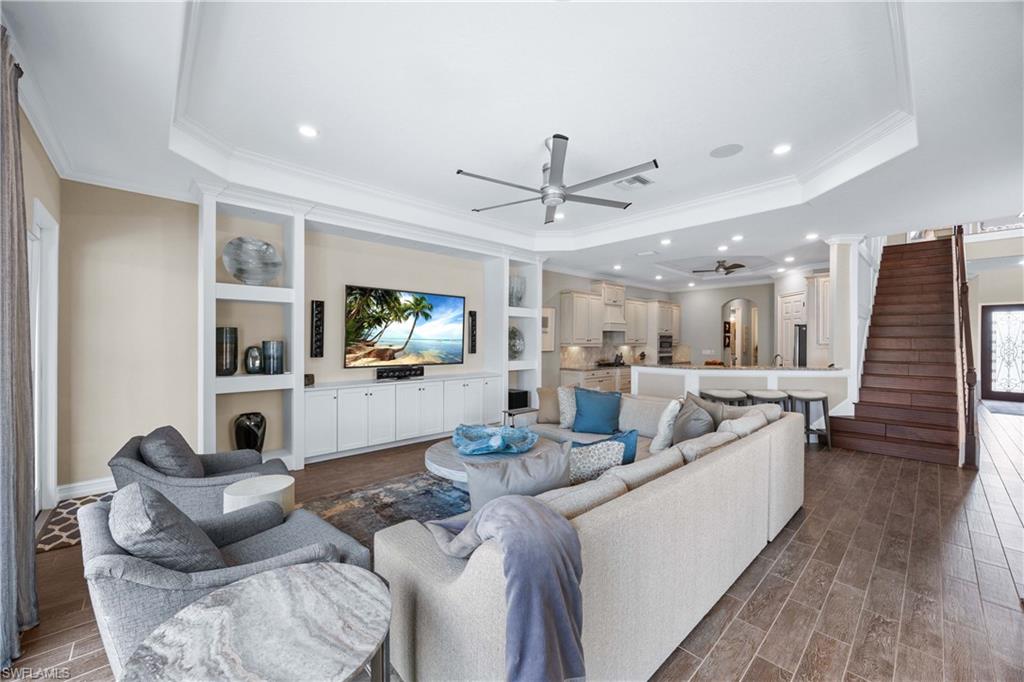 9852 Corso Bello Drive Naples, FL 34113 - Photo 6 of 50 Living area featuring a ceiling fan, ornamental molding, wood tiled floors, a raised ceiling, and recessed lighting
