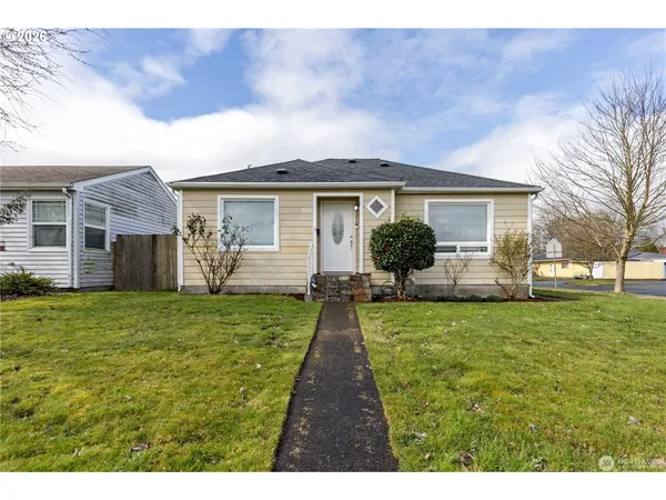 a front view of house with yard and green space