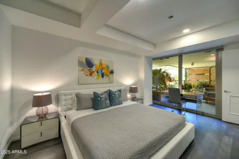 a bedroom with a large bed and a large window