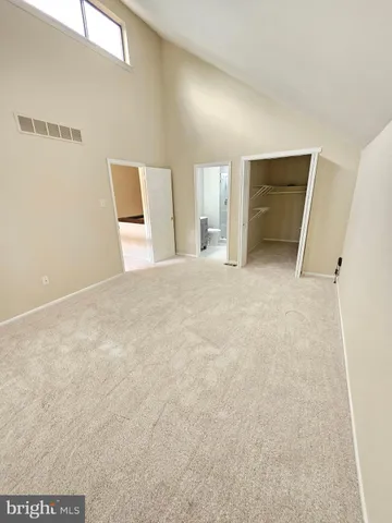 a spacious bathroom with a shower sink mirror and a toilet