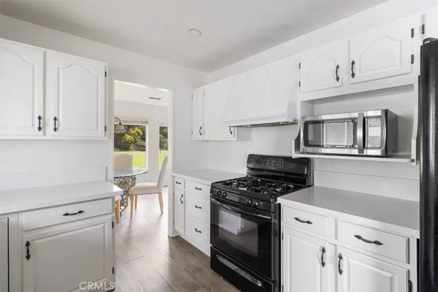 a dining room with furniture a chandelier and wooden floor