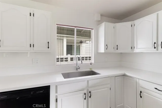 a kitchen with stainless steel appliances granite countertop a refrigerator stove and sink