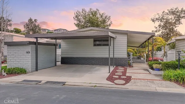 a view of a house with a small yard and plants