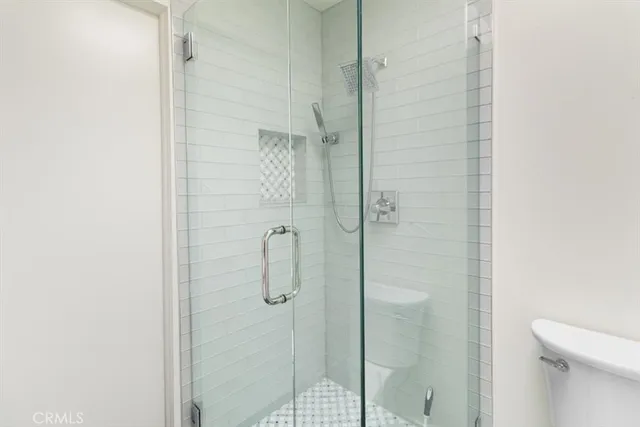 a bathroom with a shower and toilet
