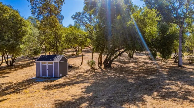 an aerial view of a house with a yard and garden