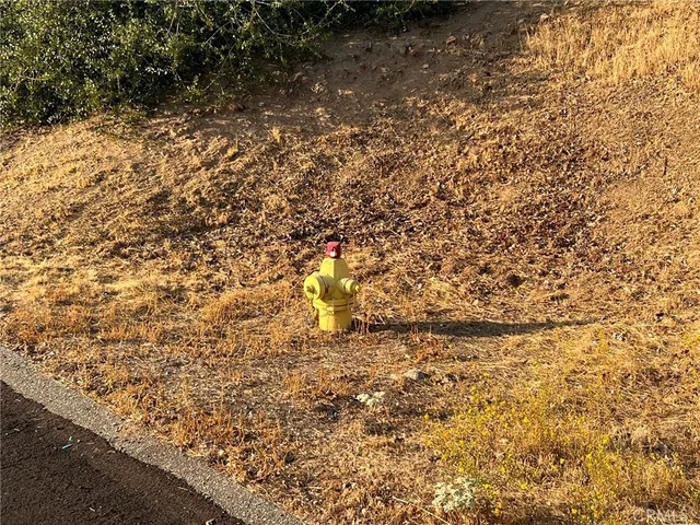 a view of a bench with wooden fence