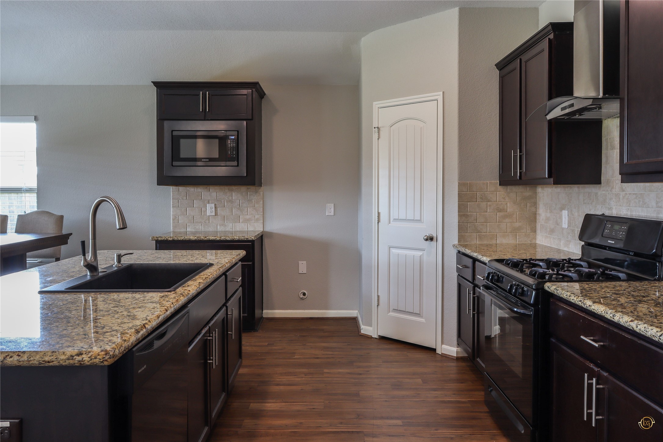 61 Rodeo Crest Drive Manvel, TX 77578 - Photo 19 of 30 a kitchen with granite countertop a sink stove and cabinets