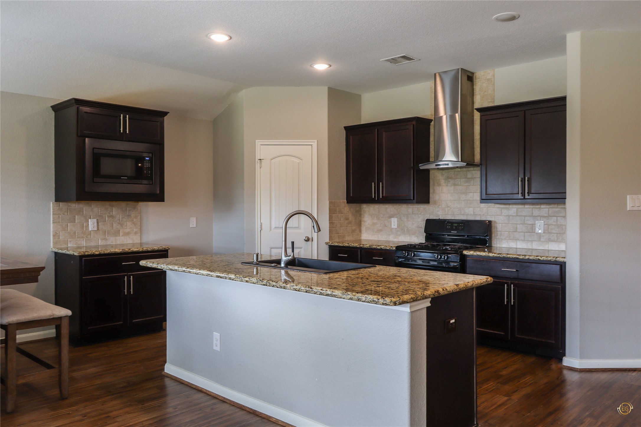 61 Rodeo Crest Drive Manvel, TX 77578 - Photo 20 of 30 a kitchen with stainless steel appliances granite countertop a sink stove and microwave