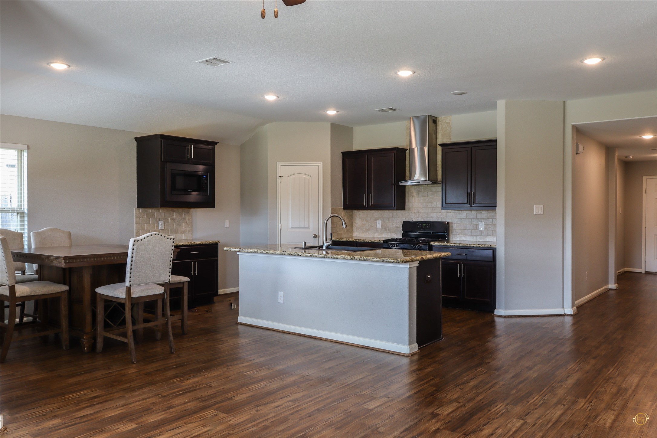 61 Rodeo Crest Drive Manvel, TX 77578 - Photo 22 of 30 a kitchen with a table and chairs in it