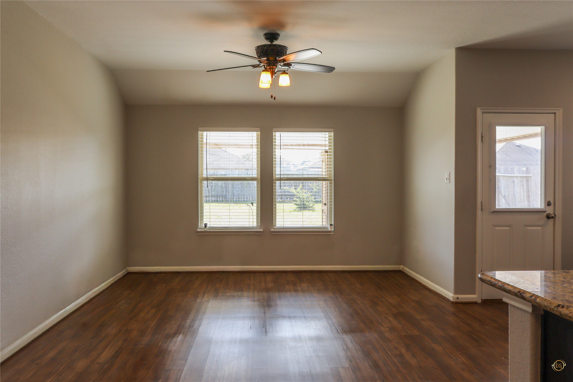 61 Rodeo Crest Drive Manvel, TX 77578 - Photo 24 of 30 an empty room with wooden floor chandelier fan and windows