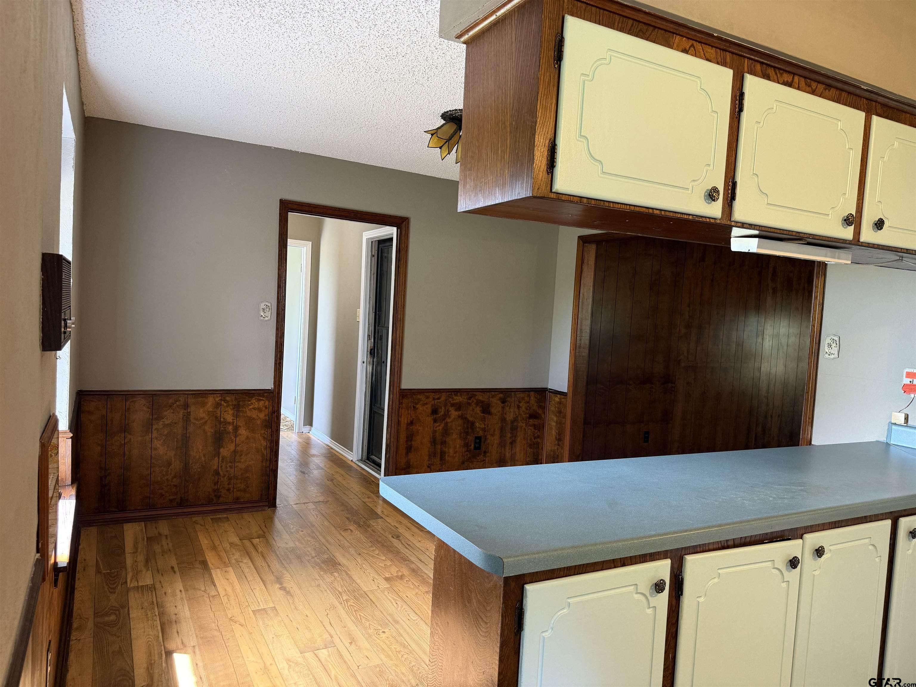 300 Black Oak Road Como, TX 75431 - Photo 11 of 34 a kitchen view with wooden cabinets