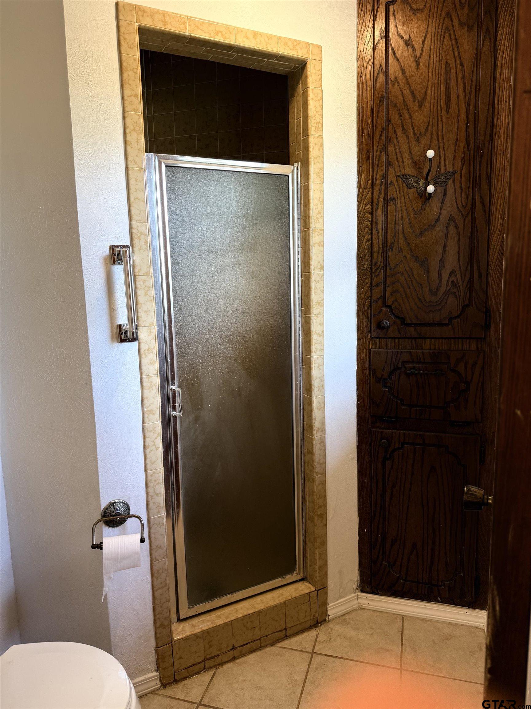 300 Black Oak Road Como, TX 75431 - Photo 16 of 34 a bathroom with a glass door shower