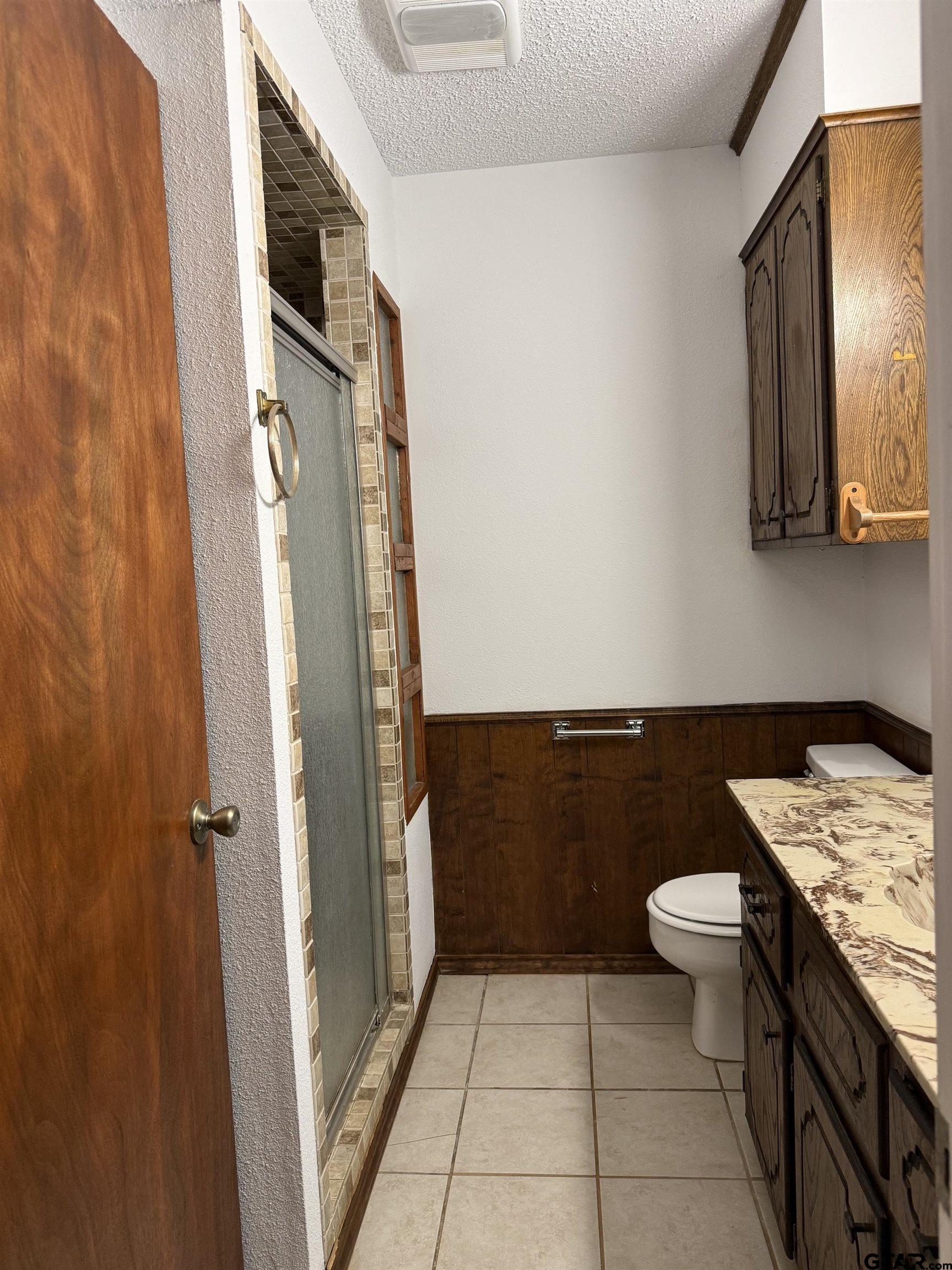 300 Black Oak Road Como, TX 75431 - Photo 18 of 34 a bathroom with a granite countertop sink a toilet and a mirror