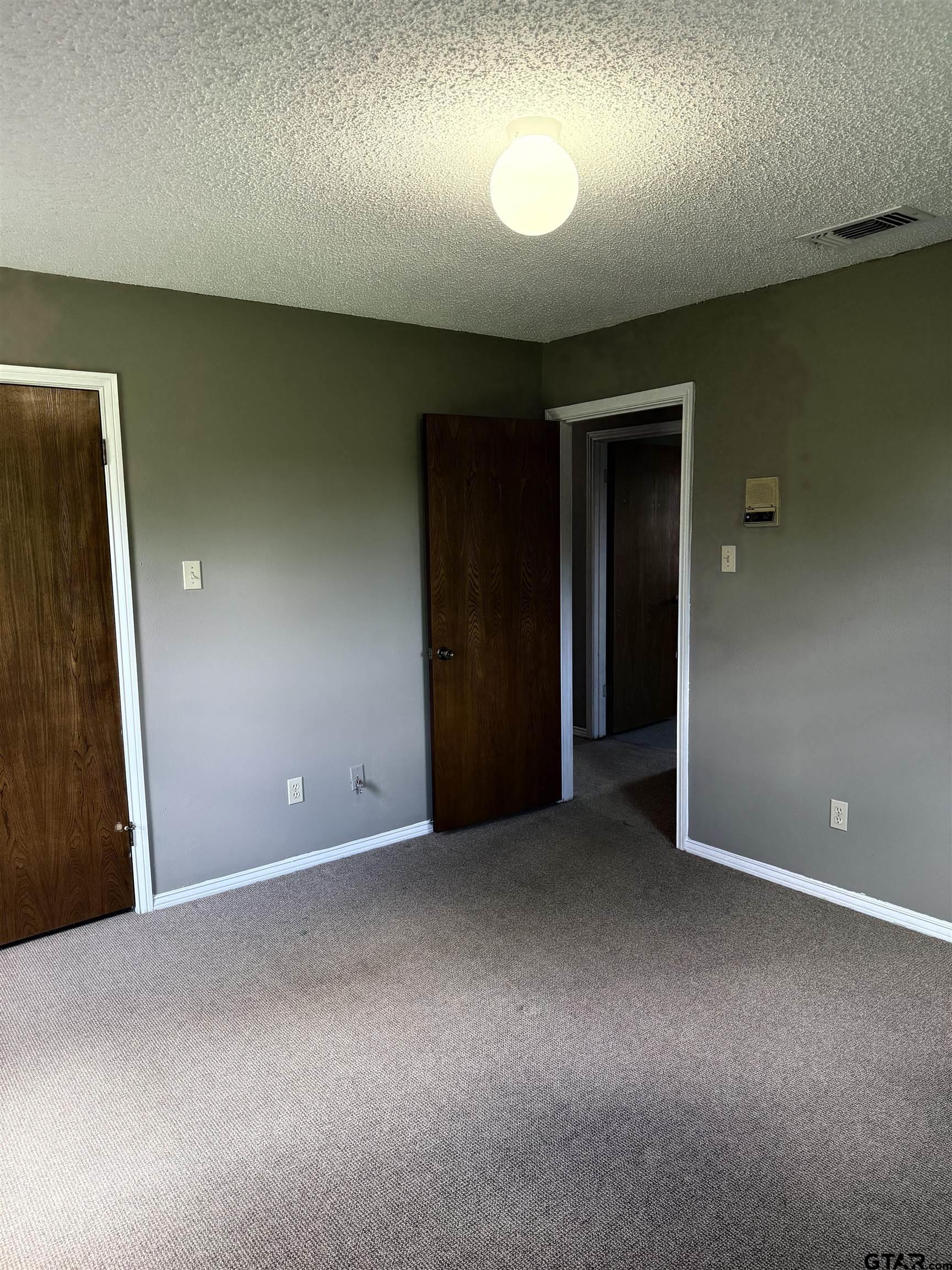 300 Black Oak Road Como, TX 75431 - Photo 20 of 34 an empty room with closet and windows