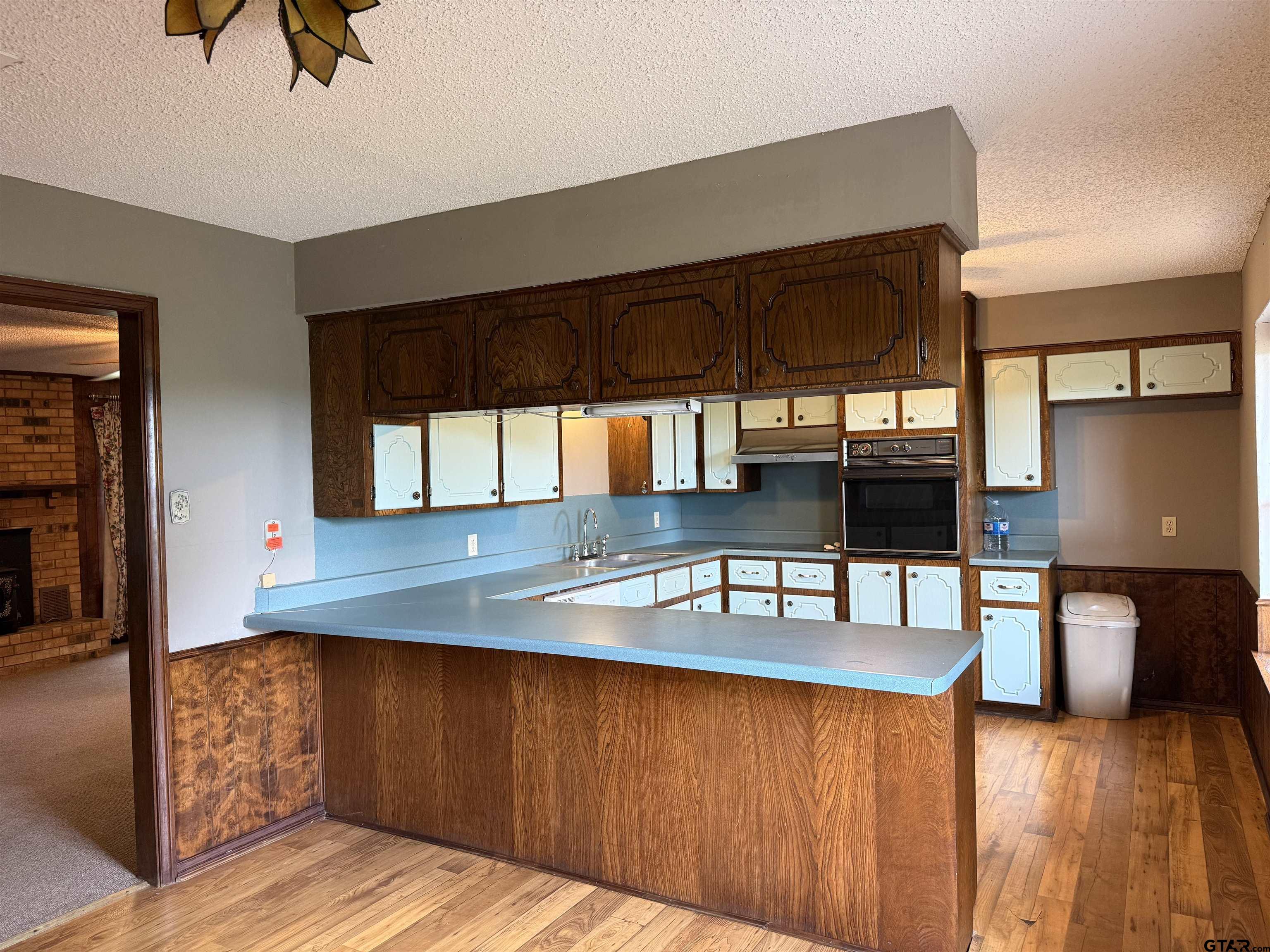 300 Black Oak Road Como, TX 75431 - Photo 9 of 34 a kitchen with kitchen island granite countertop a sink cabinets and wooden floor