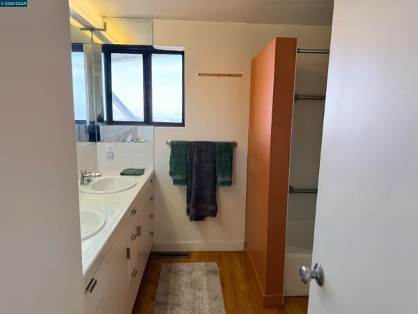 a large bed sitting in a bedroom next to a window