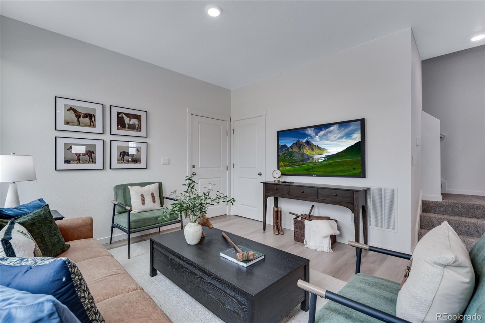 612 South Cabernet Avenue Fort Lupton, CO 80621 - Photo 12 of 49 a living room with furniture a flat screen tv and a wall painting