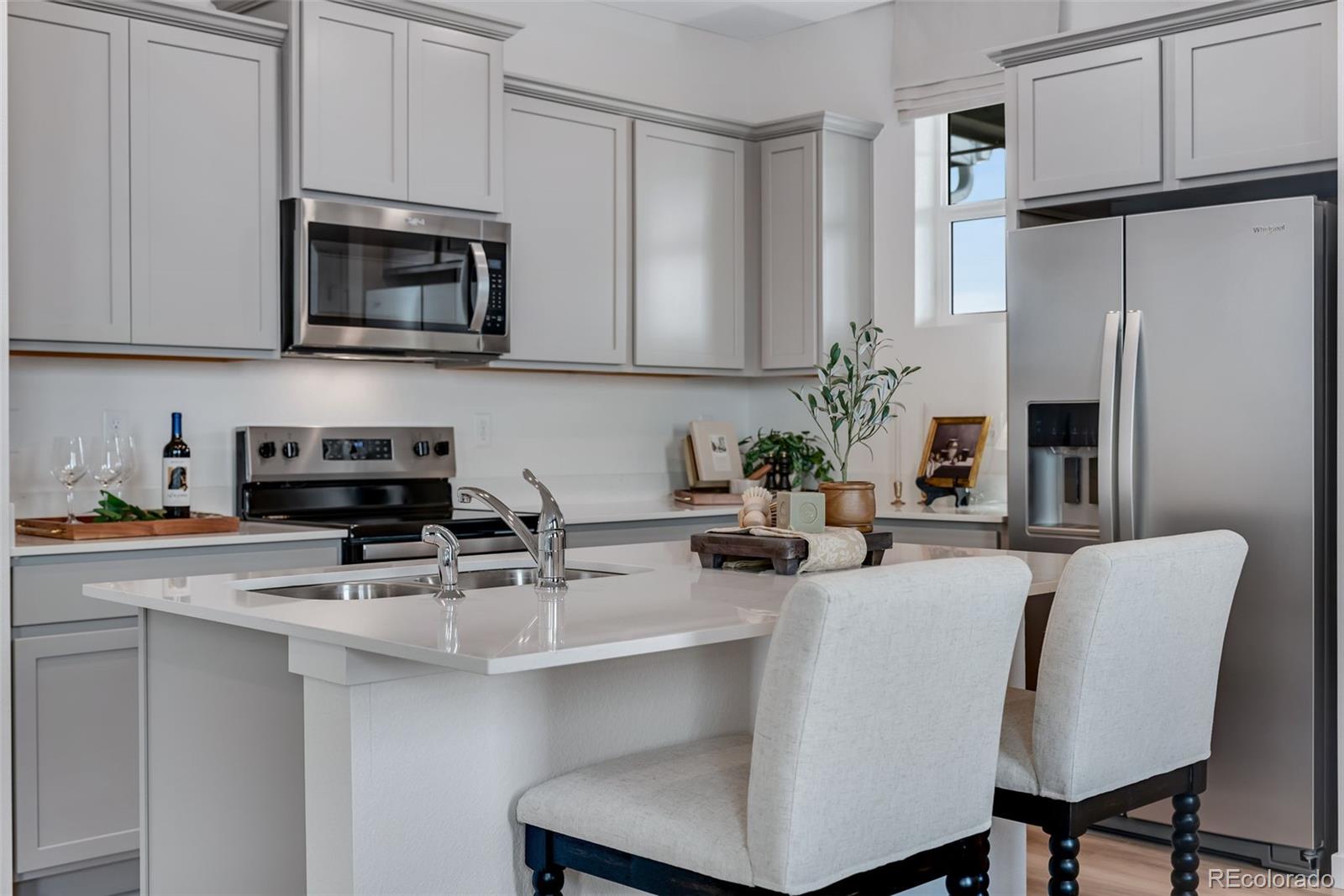 612 South Cabernet Avenue Fort Lupton, CO 80621 - Photo 15 of 49 a kitchen with stainless steel appliances a stove refrigerator sink and cabinets