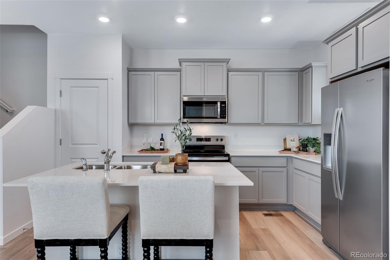 612 South Cabernet Avenue Fort Lupton, CO 80621 - Photo 16 of 49 a kitchen with a sink cabinets and refrigerator