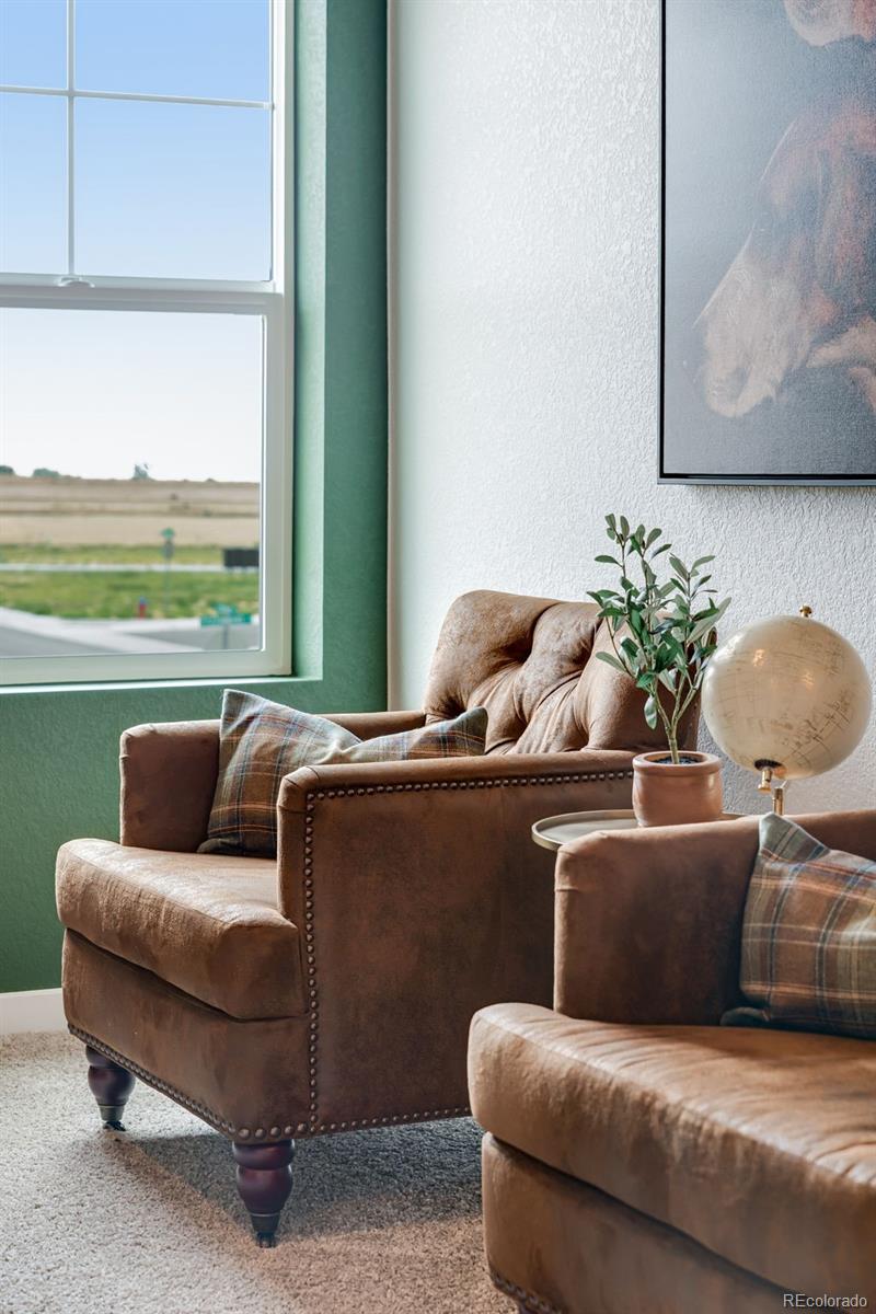 612 South Cabernet Avenue Fort Lupton, CO 80621 - Photo 28 of 49 a living room with furniture and a floor to ceiling window