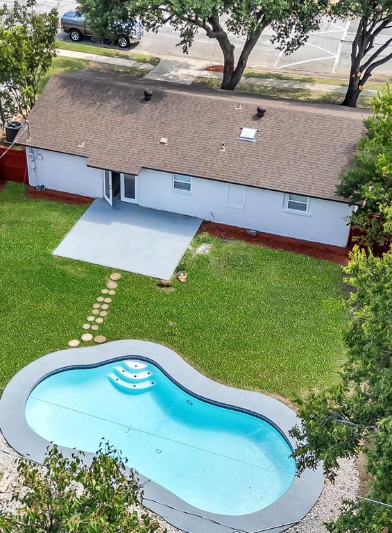a view of a swimming pool with a yard