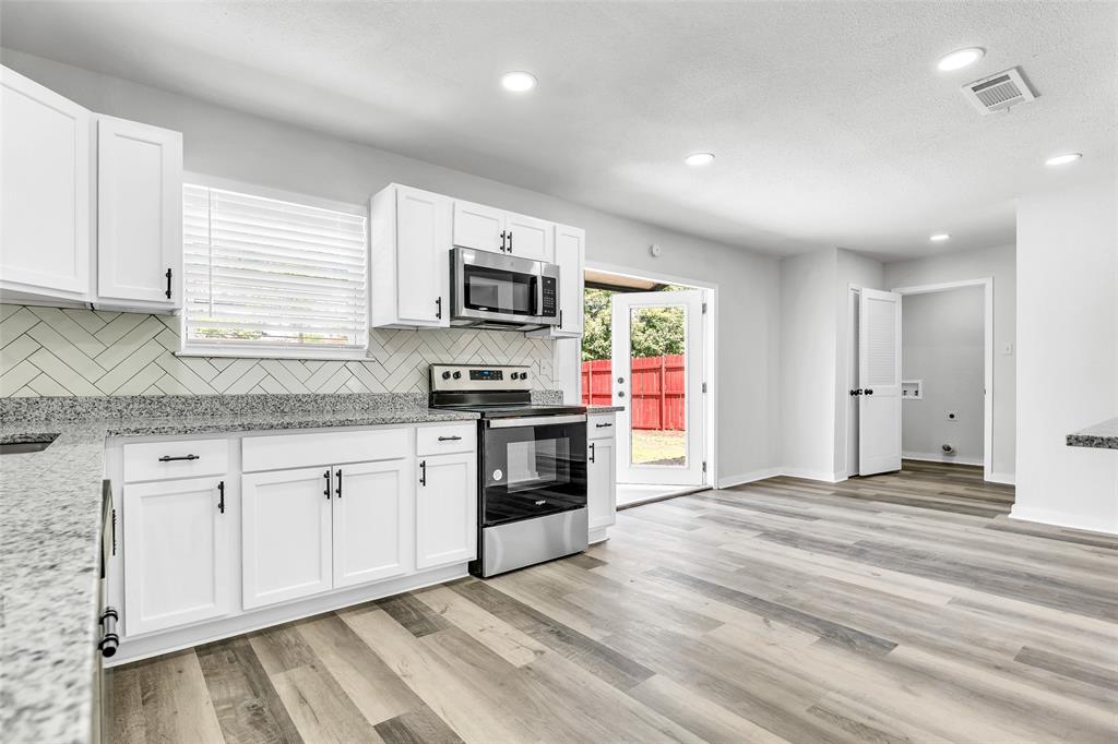 6321 Little Ranch Road North Richland Hills, TX 76182 - Photo 11 of 24 a kitchen with granite countertop a stove a sink and a refrigerator
