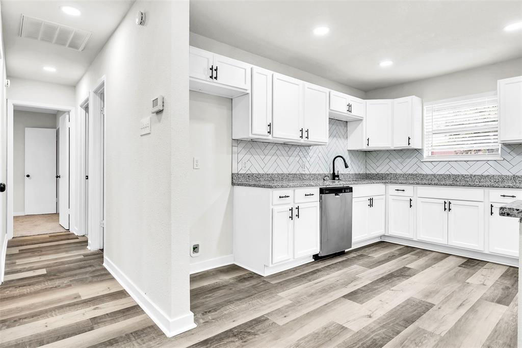 6321 Little Ranch Road North Richland Hills, TX 76182 - Photo 12 of 24 a kitchen with granite countertop white cabinets and white appliances