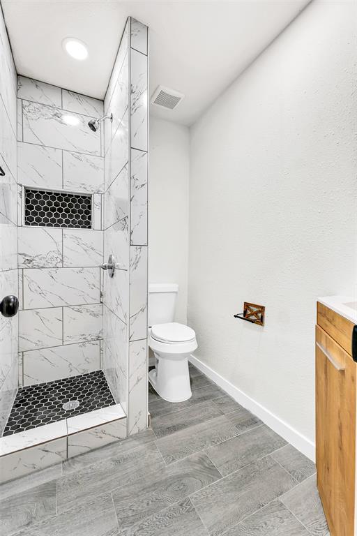 6321 Little Ranch Road North Richland Hills, TX 76182 - Photo 18 of 24 a bathroom with a toilet a sink and a shower