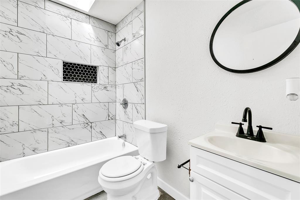 6321 Little Ranch Road North Richland Hills, TX 76182 - Photo 19 of 24 a bathroom with a sink a toilet and a mirror