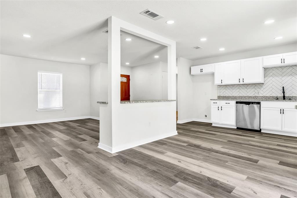 6321 Little Ranch Road North Richland Hills, TX 76182 - Photo 9 of 24 a view of a kitchen with wooden floor and a sink
