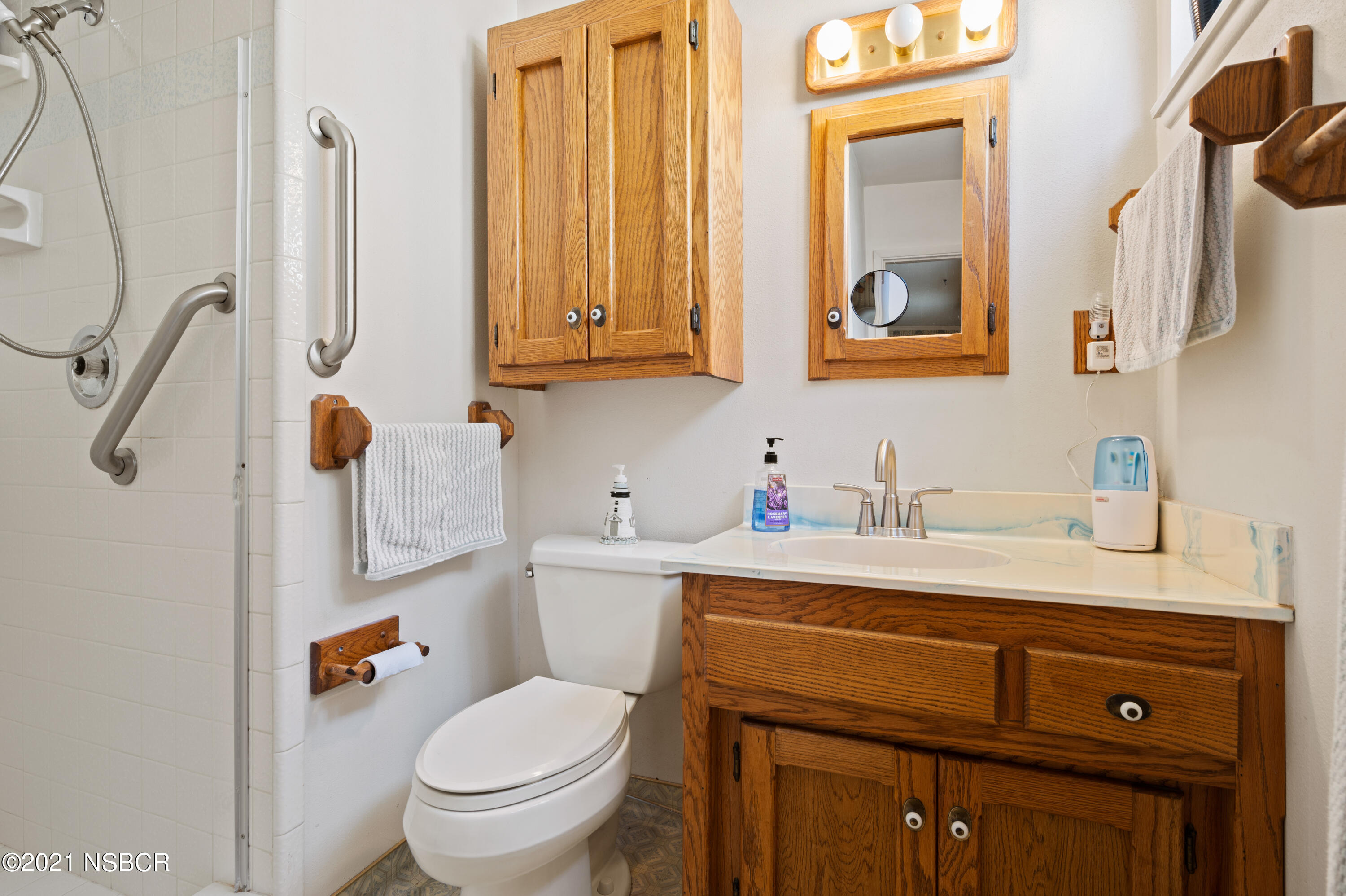 3432 Rucker Road Lompoc, CA 93436 - Photo 10 of 17 a bathroom with a granite countertop toilet sink and mirror