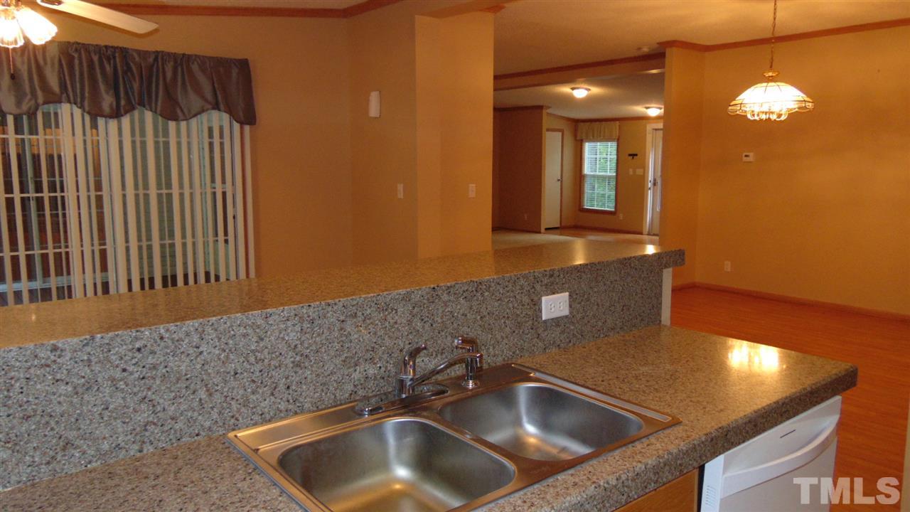 379 North Big Woods Road Spring Hope, NC 27882 - Photo 14 of 25 a kitchen with a sink and a mirror