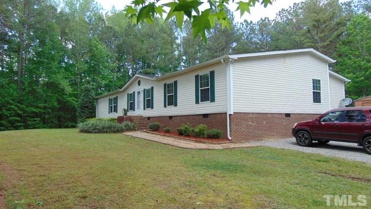 379 North Big Woods Road Spring Hope, NC 27882 - Photo 5 of 25 a front view of a house with a garden