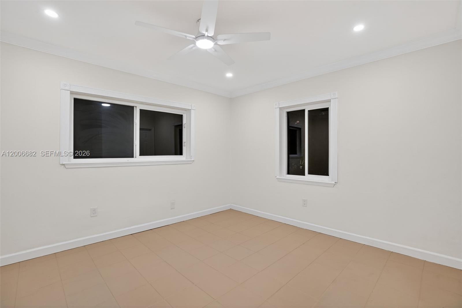 1435 Blue Road Coral Gables, FL 33146 - Photo 14 of 31 an empty room with a ceiling fan and a window