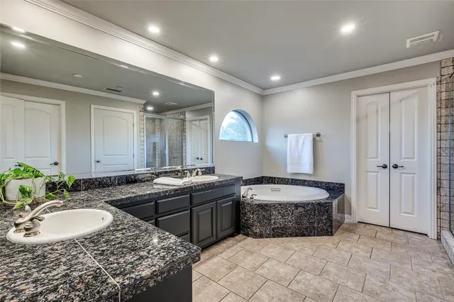 a spacious bathroom with a granite countertop sink and a mirror