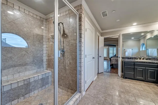 a bathroom with a granite countertop shower a sink and a mirror