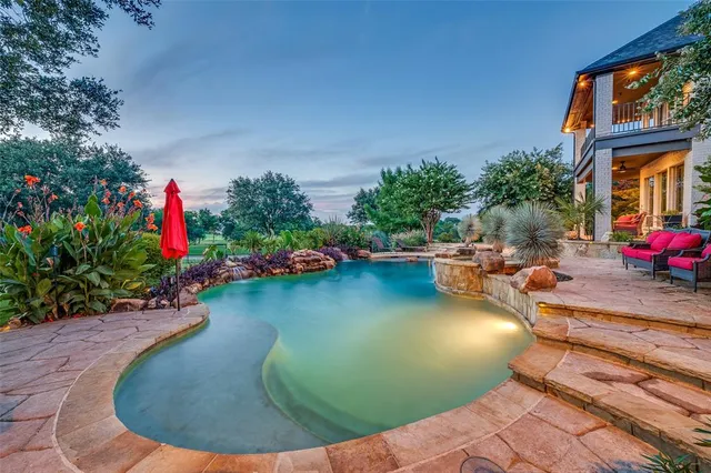 a view of a swimming pool with an outdoor seating