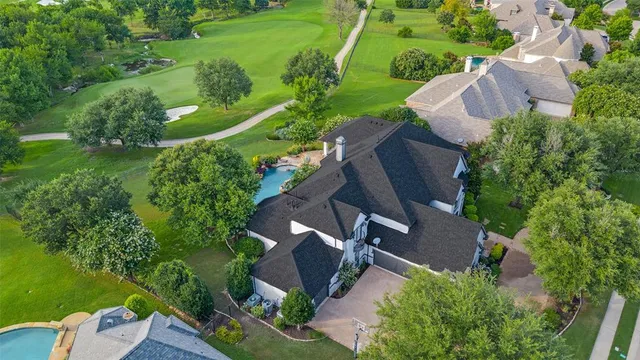 an aerial view of a house with garden space and street view