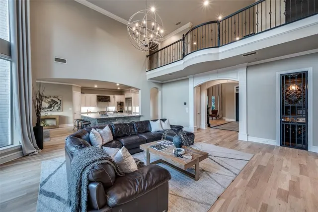 a living room with furniture and a chandelier