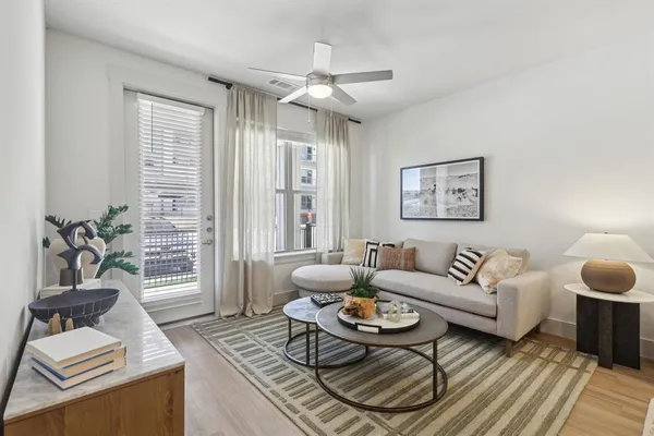 a living room with furniture a wooden floor and a chandelier