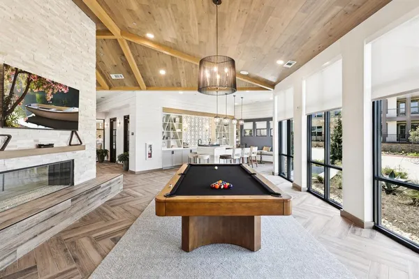 a living room with stainless steel appliances kitchen island furniture and a fireplace