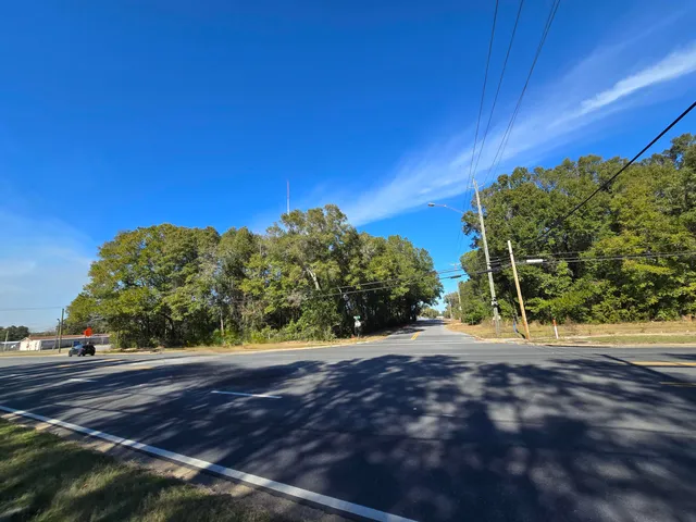 a view of a street with a yard