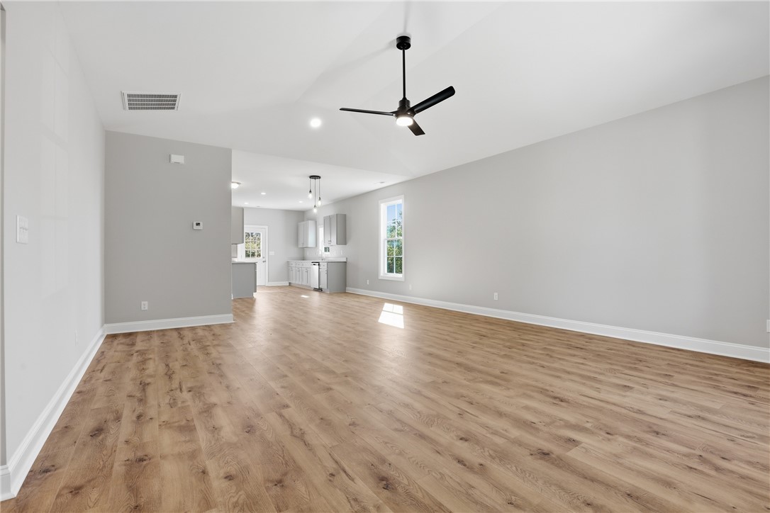311 Tribble Street Seneca, SC 29678 - Photo 32 of 33 This expansive interior features an open floorplan, showcasing beautiful flooring and a bright, airy ambiance.