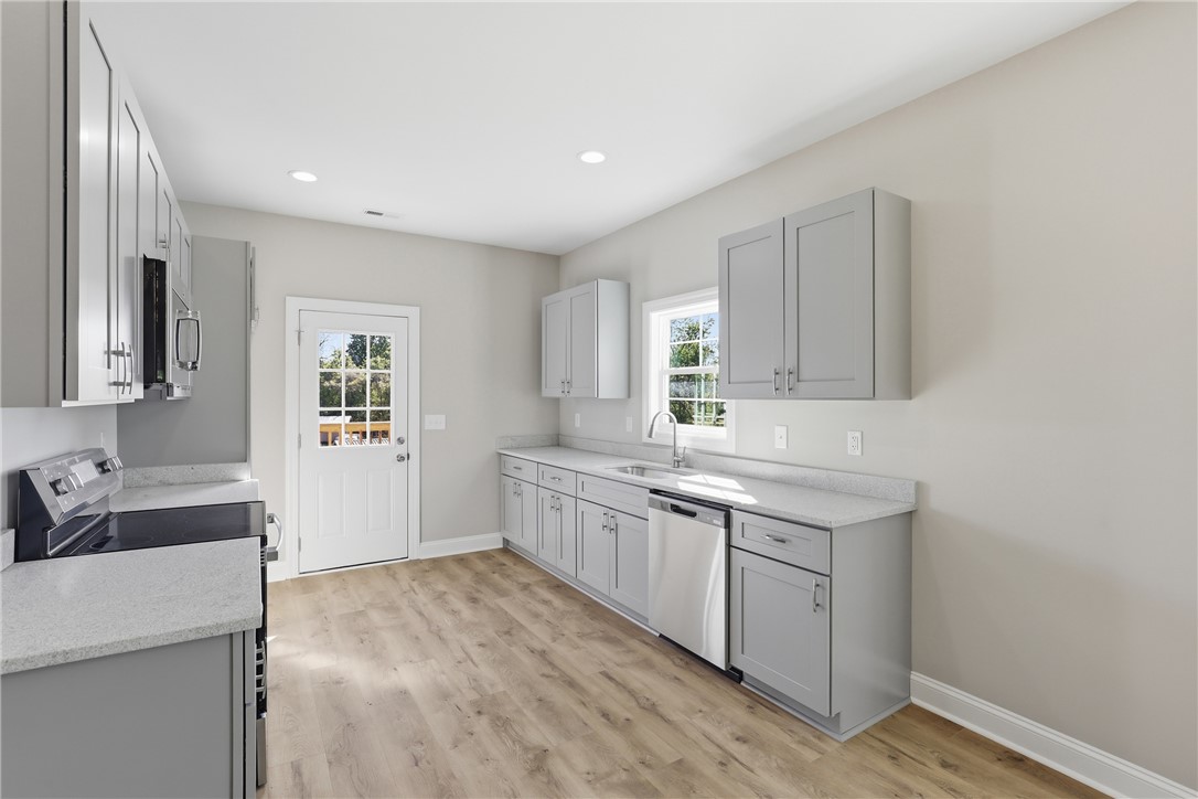 311 Tribble Street Seneca, SC 29678 - Photo 6 of 33 This bright kitchen features ample counter space and modern appliances, perfect for everyday living.