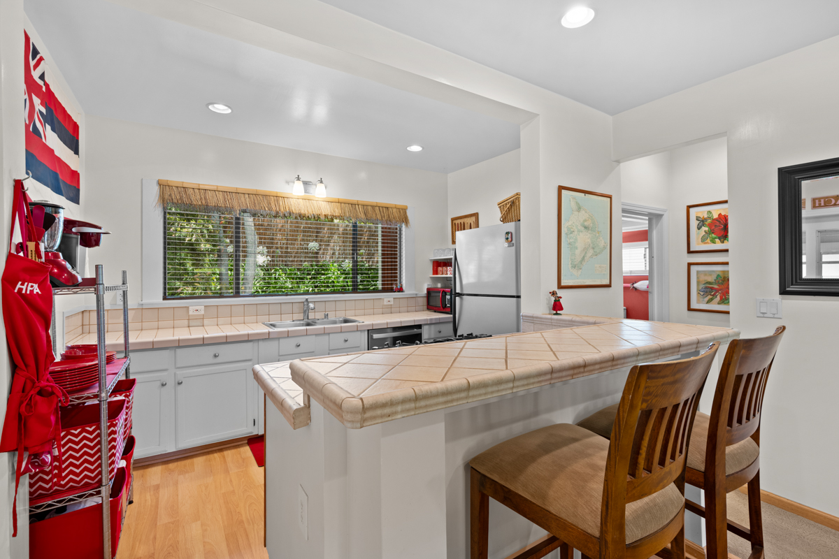 66-1685 Kohala Mountain Road Kamuela, HI 96743 - Photo 16 of 26 a dining hall with stainless steel appliances kitchen island granite countertop furniture and a large window