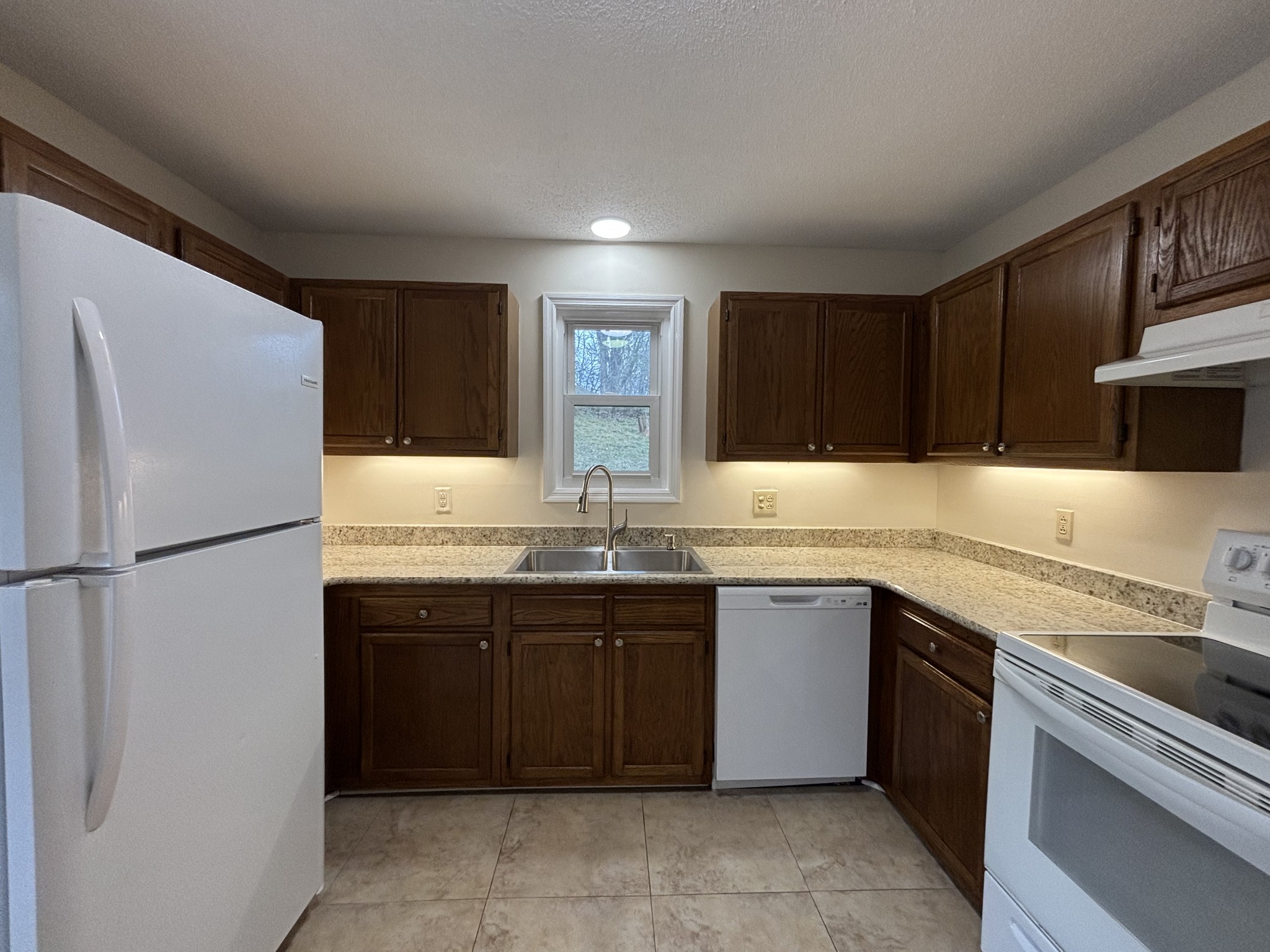 1830 Lowe Street Lewisburg, TN 37091 - Photo 10 of 22 a kitchen with a sink and a refrigerator