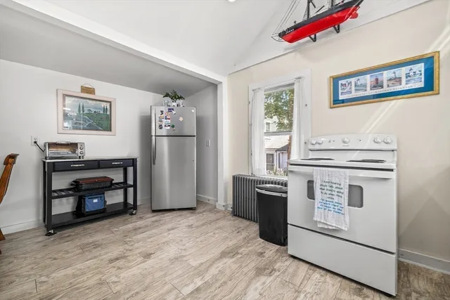 a kitchen with white cabinets sink and white appliances