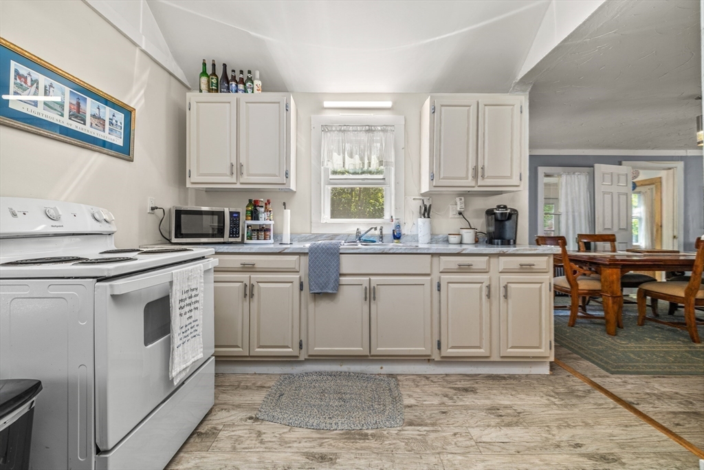 25 Union Avenue Wareham, MA 02558 - Photo 15 of 32 a kitchen with white cabinets sink and white appliances