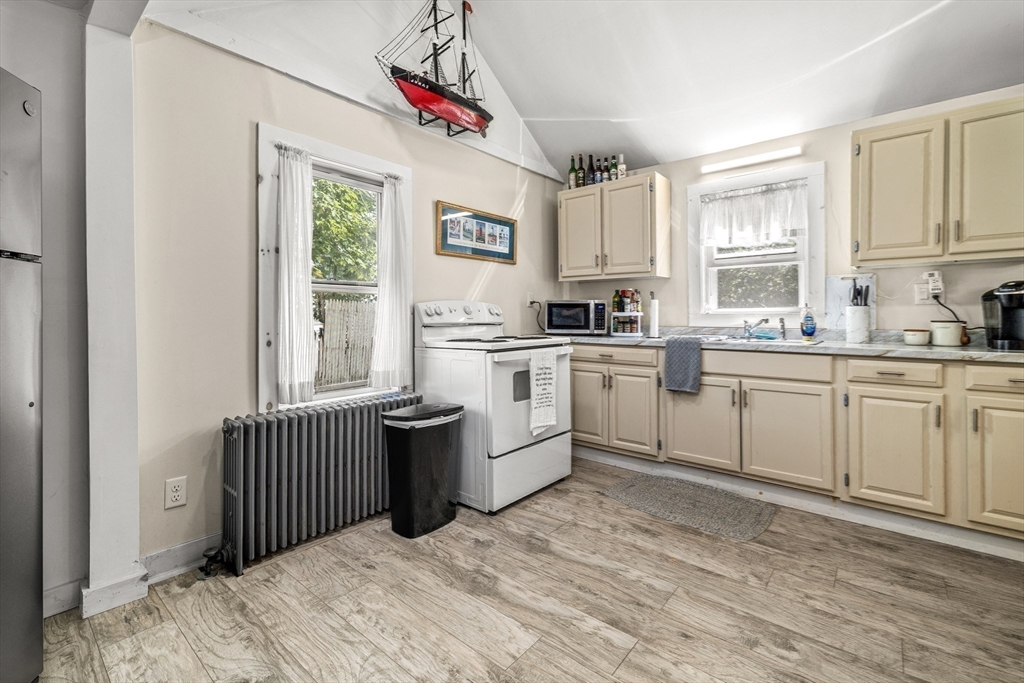 25 Union Avenue Wareham, MA 02558 - Photo 16 of 32 a kitchen with white cabinets appliances and a window